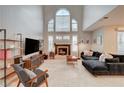 Bright living room with soaring ceilings, large windows, and modern furnishings at 8719 Villa Ariel Ln, Las Vegas, NV 89147