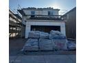 Two-story home under construction featuring a garage and visible scaffolding at 9661 Hinson St, Las Vegas, NV 89139