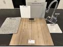 Selection of interior finishes, including light wood flooring and grey cabinets at 9661 Hinson St, Las Vegas, NV 89139