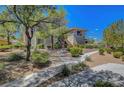 Exterior of the building with inviting sidewalk and beautiful plants and desert landscaping at 1001 Domnus Ln # 201, Las Vegas, NV 89144