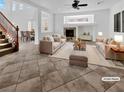 Bright, virtually staged living room featuring a fireplace, neutral furniture, and large windows with shutter blinds at 10056 Cranbrook Falls Ct, Las Vegas, NV 89148