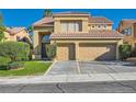 Inviting two-story home boasts a two-car garage, green lawn, and manicured shrubbery at 10241 Regents Cross Pl, Las Vegas, NV 89144