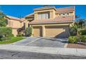 Stylish two-story house includes a two-car garage, verdant lawn, and pruned hedges at 10241 Regents Cross Pl, Las Vegas, NV 89144