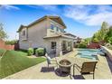 Relaxing backyard featuring a pool, spa, fire pit, lounge chairs, and patio at 10697 Acacia Park Pl, Las Vegas, NV 89135