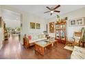 Cozy living room with hardwood floors, ceiling fan, and comfortable seating at 10697 Acacia Park Pl, Las Vegas, NV 89135