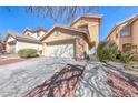 Inviting two-story home with a well-maintained front yard and desert landscaping at 11028 Meadow Leaf Ave, Las Vegas, NV 89144
