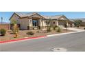 Attractive home featuring desert landscaping, a two-car garage and brick fencing at 111 Magnolia Blvd, Pahrump, NV 89048