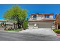 Charming two-story home with stucco exterior, well-manicured lawn, and a two car garage at 11444 Steponia Bay St, Las Vegas, NV 89141