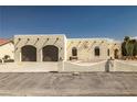 Exterior of a single-story home with desert landscaping and a circular driveway at 1320 Daytona St, Pahrump, NV 89048