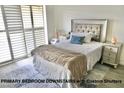 Well-lit main bedroom showcasing custom shutters, stylish decor, and comfortable bedroom furniture and neutral color palette at 153 Via Di Mello, Henderson, NV 89011