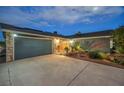 Night exterior shot of the home featuring a two-car garage and desert landscaping at 1601 Eaton Dr, Las Vegas, NV 89102