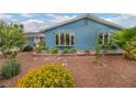 Home exterior features a well-maintained front yard with desert landscaping and bay window at 1601 Eaton Dr, Las Vegas, NV 89102
