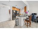 Modern kitchen featuring stainless steel appliances, wood cabinets, and a black granite countertop island at 200 W Sahara Ave # 1703, Las Vegas, NV 89102