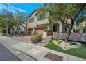 Two-story home featuring a brick driveway, a three-car garage and desert landscaping at 205 Piedmont Alps St, Henderson, NV 89012