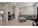 Comfortable living room with a stylish sofa, ottoman, and space for a home office at 205 Piedmont Alps St, Henderson, NV 89012