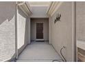 Inviting front entryway with a covered porch and a rustic decor accent at 2108 Willow Wren Dr, North Las Vegas, NV 89084