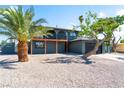 Two-story home exterior featuring a balcony, two-car garage, and desert landscaping at 2180 Palora Ave, Las Vegas, NV 89169