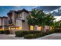 Lovely two-story home with a two-car garage, attractive landscaping, and a welcoming entrance at 2435 Granada Bluff Ct, Las Vegas, NV 89135