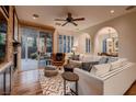 Bright and airy living room with hardwood floors, a fireplace, and sliding glass doors at 2435 Granada Bluff Ct, Las Vegas, NV 89135