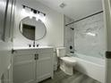 Stylish bathroom with a marble tile surround, modern vanity, and black fixtures at 2606 S Durango Dr # 263, Las Vegas, NV 89117
