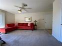 Bright living room boasts a large red sectional, neutral walls, and plush carpeting at 2606 S Durango Dr # 263, Las Vegas, NV 89117