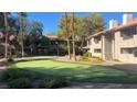 Exterior view of a putting green surrounded by mature landscaping and trees at 2606 S Durango Dr # 263, Las Vegas, NV 89117
