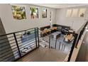 Open kitchen and dining area with modern appliances and island, as seen from the staircase at 2672 Mystere Ct, Las Vegas, NV 89117