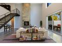 Bright living room with a fireplace, high ceilings, and a view of the outdoor dining area at 2672 Mystere Ct, Las Vegas, NV 89117