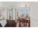 Dining room with hardwood floors, a modern light fixture, and city views through large windows at 2777 Paradise Rd # 1105, Las Vegas, NV 89109