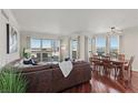 Open-concept living room with a brown leather couch, dining area, and expansive windows showcasing the cityscape at 2777 Paradise Rd # 1105, Las Vegas, NV 89109