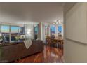 Open living room with hardwood floors, city views, and adjacent dining area at 2777 Paradise Rd # 1105, Las Vegas, NV 89109