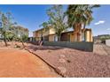 Exterior view of a multi-unit home with desert landscaping and mature trees at 301 E Van Wagenen St, Henderson, NV 89015