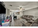 Cozy living room featuring wood-look floors and a modern ceiling fan at 301 E Van Wagenen St, Henderson, NV 89015