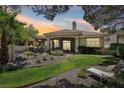 A gorgeous backyard provides ample space for outdoor living, complete with lush green grass and stone landscaping at 304 Cambrian Ridge Ct, Las Vegas, NV 89144