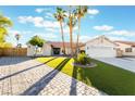 Attractive single-story home featuring a lush lawn and stylish brick driveway at 3099 Palmdesert Way, Las Vegas, NV 89120