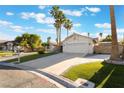 Inviting single-story home with lush lawn, mature trees, and a spacious two car garage at 3099 Palmdesert Way, Las Vegas, NV 89120