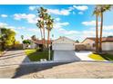 Charming single-story home with desert landscaping, mature palm trees and a spacious driveway at 3099 Palmdesert Way, Las Vegas, NV 89120