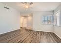 Bright living room featuring modern laminate wood flooring, neutral paint, and natural light at 318 Heather Dr, Henderson, NV 89002