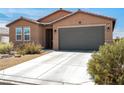 Inviting single-story home with a two-car garage and desert landscaping at 3543 E Malheur Ave, Pahrump, NV 89061