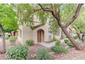 Charming home with well-maintained landscaping, mature trees, and a welcoming front entrance at 3930 Legend Hills St # 102, Las Vegas, NV 89129