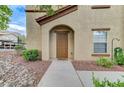 Close-up of the building's entrance featuring an arched doorway and neutral exterior at 3930 Legend Hills St # 102, Las Vegas, NV 89129