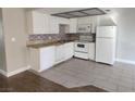 Bright kitchen with white cabinets, tile flooring, and stainless steel appliances at 4300 N Lamont St # 249, Las Vegas, NV 89115