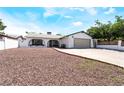 Welcoming single-story home featuring a spacious driveway, secure gated fence, and low-maintenance yard at 4323 E Twain Ave, Las Vegas, NV 89121