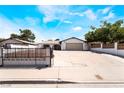 Cozy single-story home with a spacious driveway and secure gated fence for added privacy and security at 4323 E Twain Ave, Las Vegas, NV 89121