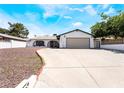 Inviting single-story home featuring a spacious driveway and secure gated fence for added security at 4323 E Twain Ave, Las Vegas, NV 89121
