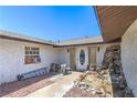 Welcoming front entry with a white door and desert rock landscaping at 4461 Greenhill Dr, Las Vegas, NV 89121