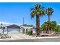Inviting home featuring desert landscaping, a two-car garage, and a quaint, covered entrance at 4461 Greenhill Dr, Las Vegas, NV 89121