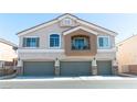 Two-story townhome with multi-car garage, balcony, and neutral stucco exterior at 4521 Bell Cord Ave # 103, North Las Vegas, NV 89031