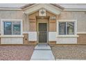 Inviting front entrance with security screen door and well-maintained landscaping at 4521 Bell Cord Ave # 103, North Las Vegas, NV 89031