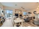 Cozy living room featuring a fireplace, ceiling fan, and a sliding door for outdoor access at 4521 Bell Cord Ave # 103, North Las Vegas, NV 89031